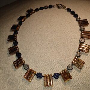 Victoria Tane: Gold tone, silver tone, and blue Choker style necklace.